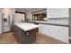 Bright eat-in kitchen with stainless steel appliances, an island, and white cabinetry at 8155 E Juan Tabo Rd, Scottsdale, AZ 85255