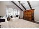 Spacious living room with vaulted ceiling, exposed beams, and a wall unit for storage at 8155 E Juan Tabo Rd, Scottsdale, AZ 85255