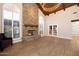 Bright living room with vaulted ceilings, a brick fireplace, and hardwood floors at 8155 E Juan Tabo Rd, Scottsdale, AZ 85255