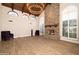 Bright living room with vaulted ceilings, a brick fireplace, and hardwood floors at 8155 E Juan Tabo Rd, Scottsdale, AZ 85255