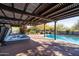 Relaxing backyard pool and spa area surrounded by wooden deck with pergola at 8155 E Juan Tabo Rd, Scottsdale, AZ 85255