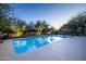 Inviting pool area with comfortable lounge chairs and desert landscaping featuring trees lit with festive lights at 8155 E Juan Tabo Rd, Scottsdale, AZ 85255