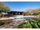 Outdoor swimming pool with a covered patio and well-manicured backyard at 8155 E Juan Tabo Rd, Scottsdale, AZ 85255