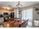 Dining area with rustic wood table, backyard access, and view of the bright kitchen at 8551 E Kiowa Ave, Mesa, AZ 85209
