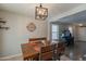 Dining area with wood table and views of a living room with dark hard wood floors at 8551 E Kiowa Ave, Mesa, AZ 85209