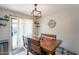 Dining area with wood table, chandelier, patio access, and backyard pool view at 8551 E Kiowa Ave, Mesa, AZ 85209