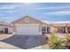 Charming single-story home with desert landscaping and a two-car garage under a clear blue sky at 8551 E Kiowa Ave, Mesa, AZ 85209