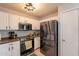 Well-equipped kitchen boasting stainless steel appliances, white cabinetry, and a functional layout for cooking at 8551 E Kiowa Ave, Mesa, AZ 85209