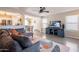 Well-lit living space showcasing a modern sofa, television, and an open layout leading to the dining area and kitchen at 8551 E Kiowa Ave, Mesa, AZ 85209