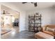 Open living area with grey wood-look floors, an accent chair and a bookcase at 8551 E Kiowa Ave, Mesa, AZ 85209