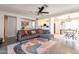 Open-concept living room with modern decor, a comfortable sofa, and seamless flow to the kitchen area at 8551 E Kiowa Ave, Mesa, AZ 85209