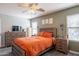 Main bedroom showcasing wood furnishings, a ceiling fan, and multiple windows at 8551 E Kiowa Ave, Mesa, AZ 85209