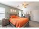 Comfortable main bedroom featuring a ceiling fan, ample windows, and neutral wall paint at 8551 E Kiowa Ave, Mesa, AZ 85209
