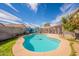 Backyard pool area with a covered patio, landscaping, and privacy fence at 8551 E Kiowa Ave, Mesa, AZ 85209
