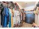 Walk-in closet with shelving and a variety of clothing at 8551 E Kiowa Ave, Mesa, AZ 85209