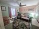 Charming bedroom with colorful décor, a cozy rocking chair, and soft, inviting textiles at 8662 W Paradise Ln, Peoria, AZ 85382
