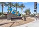 Charming Peoria community sign with sunflowers, bees, and palm trees under a sunny blue sky at 8662 W Paradise Ln, Peoria, AZ 85382