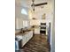 An updated kitchen with stainless steel appliances, white cabinets, a stainless steel sink, and granite countertops at 8662 W Paradise Ln, Peoria, AZ 85382