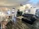 Inviting living area with vaulted ceilings, a comfortable leather sectional, and bright, natural light at 8662 W Paradise Ln, Peoria, AZ 85382
