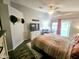 Bright main bedroom with wood flooring, a ceiling fan, and a view of the backyard pool at 8662 W Paradise Ln, Peoria, AZ 85382