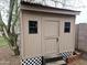 Exterior view of a charming playhouse, featuring a red tin roof, windows, and a small door at 8662 W Paradise Ln, Peoria, AZ 85382