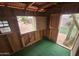 Interior view of a playhouse with green carpet, wood walls, and a small window at 8662 W Paradise Ln, Peoria, AZ 85382