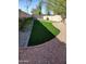 Backyard putting green with lush artificial turf, surrounded by desert landscaping and gravel at 8662 W Paradise Ln, Peoria, AZ 85382