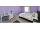 Charming bedroom with lavender walls, bright window, and vintage writing desk at 8819 N 12Th Pl, Phoenix, AZ 85020