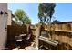 Cozy outdoor patio area with wooden fence, a table setting and an outdoor decoration display at 8819 N 12Th Pl, Phoenix, AZ 85020