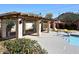Community pool, featuring a pergola, mountains in background, lounge chairs, and lush landscaping at 8819 N 12Th Pl, Phoenix, AZ 85020