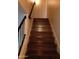 View of an indoor staircase with wood treads and a dark metal handrail leading to the upper level of the home at 8819 N 12Th Pl, Phoenix, AZ 85020