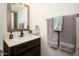 A cozy bathroom featuring dark wood cabinetry, a white countertop, and neutral walls at 921 W University Dr # 1143, Mesa, AZ 85201
