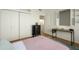 Bedroom view with a desk, closet, window with shutters, and a pink blanket at 921 W University Dr # 1143, Mesa, AZ 85201