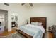 Bedroom featuring a wooden bed frame, carpet, a ceiling fan, and an ensuite bathroom at 921 W University Dr # 1143, Mesa, AZ 85201