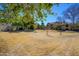 A common area with dry grass and trees, nestled among homes, offers community gathering at 921 W University Dr # 1143, Mesa, AZ 85201