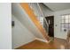 View of the home's entryway showcasing wood flooring and a staircase with wood treads and white risers at 921 W University Dr # 1143, Mesa, AZ 85201