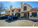Exterior view of the home and the parking lot showing the architecture and landscaping at 921 W University Dr # 1143, Mesa, AZ 85201