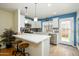 Bright kitchen with white cabinets, tile backsplash, a breakfast bar and stainless steel appliances at 921 W University Dr # 1143, Mesa, AZ 85201