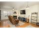 Cozy living room with a fireplace, a plush recliner, and ample natural light, creating a warm and inviting atmosphere at 921 W University Dr # 1143, Mesa, AZ 85201