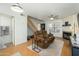 Comfortable living room with wood floors, a ceiling fan, a fireplace, and stairway access to the upper floor at 921 W University Dr # 1143, Mesa, AZ 85201