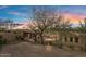 Long, inviting driveway with brick pavers, leading up to a rustic gate, a multi-car garage, and lush desert landscaping at 9718 N Four Peaks Way, Fountain Hills, AZ 85268