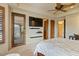 Lovely main bedroom featuring a ceiling fan, doors to the outside, and flat screen tv at 9718 N Four Peaks Way, Fountain Hills, AZ 85268