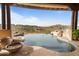 Infinity pool features unique rock waterfall design with an incredible view of the desert hillside community at 9718 N Four Peaks Way, Fountain Hills, AZ 85268