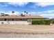 Wide backyard with desert landscaping and mature bushes adding privacy to the property at 10801 W Mountain View Rd, Sun City, AZ 85351