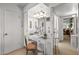 Inviting bathroom with bright lights, vanity, and decorative mirror at 10801 W Mountain View Rd, Sun City, AZ 85351