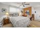 Cozy bedroom boasts a ceiling fan, and stylish decor with bright pops of color at 10801 W Mountain View Rd, Sun City, AZ 85351