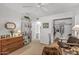 Light bedroom with neutral carpet, closet, shelving, and a chest of drawers at 10801 W Mountain View Rd, Sun City, AZ 85351