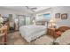 Bright bedroom featuring a ceiling fan, sliding glass door, and ample natural light at 10801 W Mountain View Rd, Sun City, AZ 85351