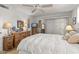 Comfortable bedroom with a ceiling fan, a dresser, and sliding glass door at 10801 W Mountain View Rd, Sun City, AZ 85351