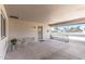 A cozy carport provides sheltered parking with a seating area and a secure entry door for added comfort and peace of mind at 10801 W Mountain View Rd, Sun City, AZ 85351